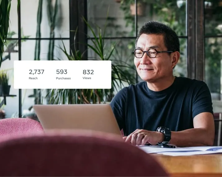 Man in front of laptop buying Facebook ads