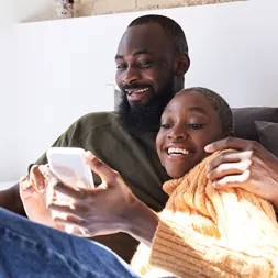 Couple engaging in mobile educational content at home