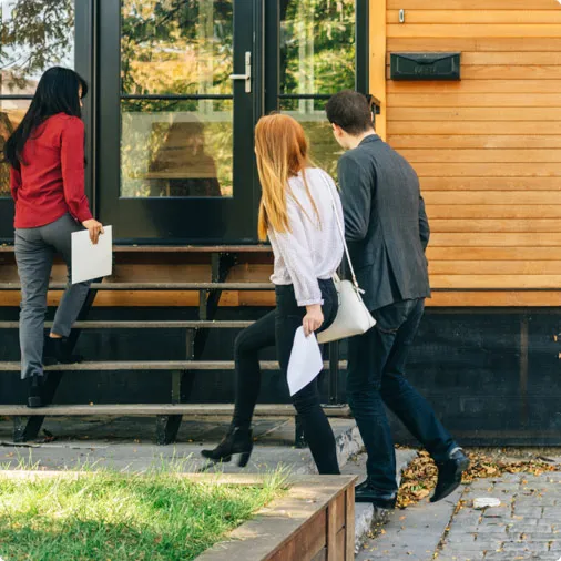 Facebook lead ads property marketing – interested buyers walk into home for sale with estate agent to meet with seller