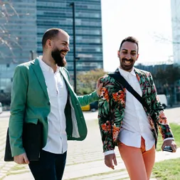 Two men engaging in conversation on an educational campus