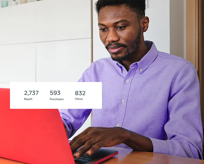 Man sitting in front of laptop, looking at data about business reach, purchases and views.