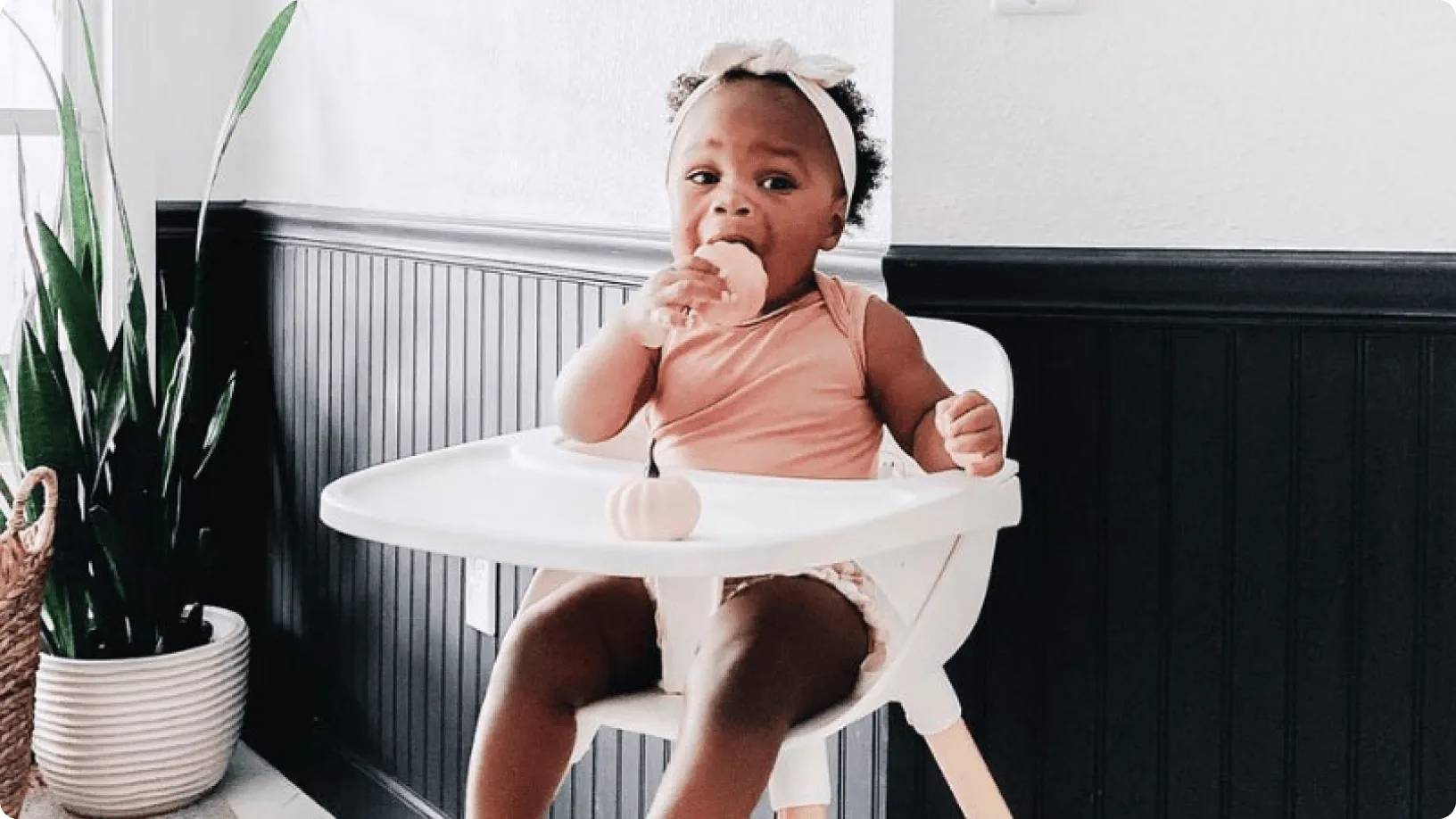 Lalo success story with a baby sitting in a high chair