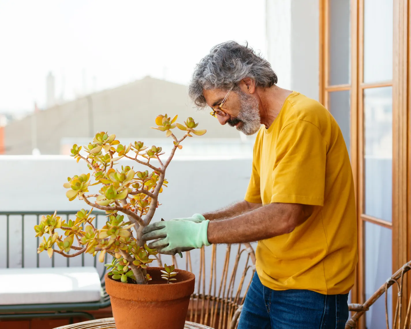 man outdoors tending to plant