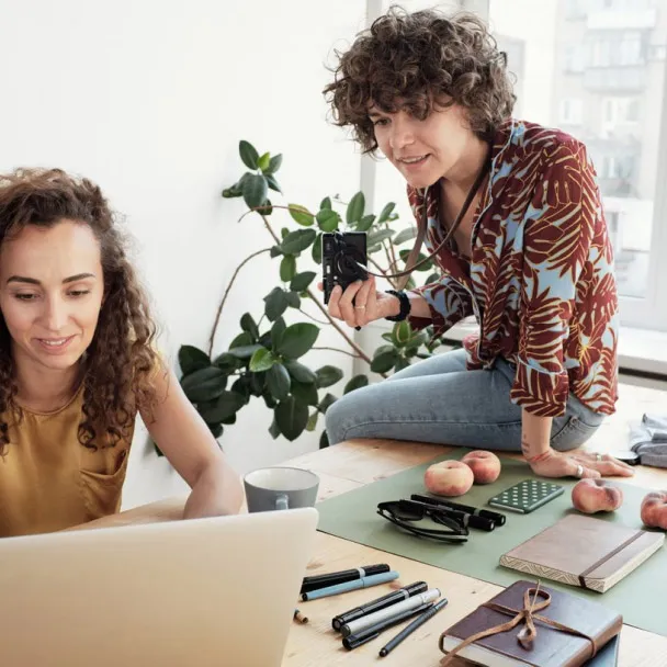 Two people working at a desk contacting Facebook Business Partners