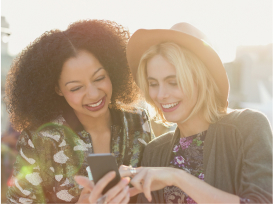 two friends watching their phone